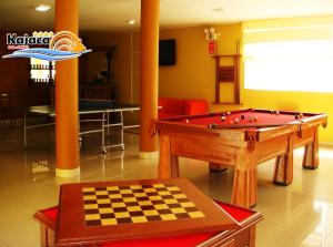 Zimmer mit Billardtisch und Schachbrett in der Unterkunft Kajaca Suite Hotel in Huacho