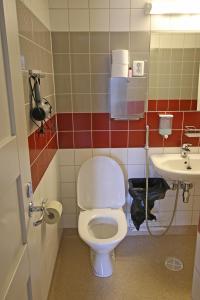 a bathroom with a toilet and a sink at Villa Huvila in Savonlinna