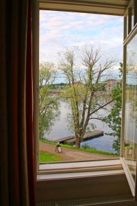 a window with a view of a body of water at Villa Huvila in Savonlinna