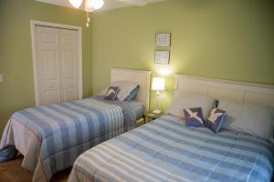 two beds in a room with green walls at Pawley's True Blue in Pawleys Island +13 photos