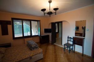 a bedroom with a bed and a desk and a chair at Snow Heaven Hotel in Bankya