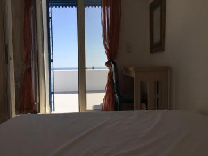a bedroom with a bed and a view of the ocean at Appartement - Vue sur Mer- Hammamet in Hammamet