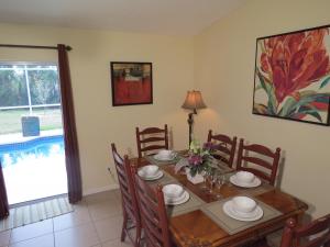 a dining room with a wooden table and chairs at Westridge Pool Home in Davenport