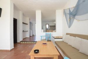 a living room with a couch and a table at Binibeca Beach Villas in Binibeca