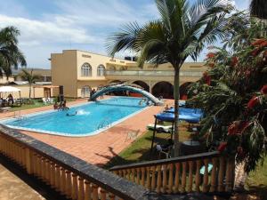 a swimming pool with a slide in a resort at Brisk Hotel Triangle in Jinja