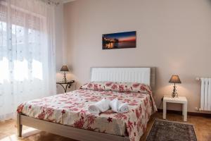 a bedroom with a bed with a red comforter at La Castellese in Aci Castello