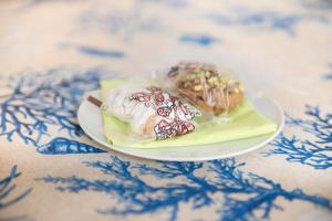 two desserts on a plate on a table at La Castellese in Aci Castello