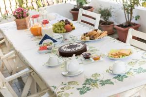 a table with a cake and a plate of food at La Castellese in Aci Castello