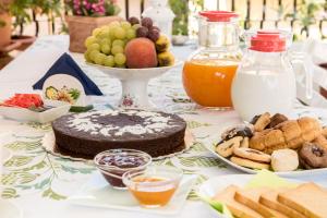 a table topped with a cake and a plate of food at La Castellese in Aci Castello