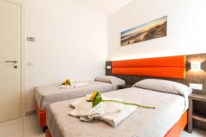 Ένα ή περισσότερα κρεβάτια σε δωμάτιο στο Residence Perla Verde +56 φωτογραφίες