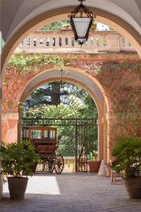 an archway with a carriage in a brick wall at Palazzo Laura in Morciano di Leuca