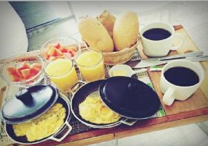 a table with breakfast foods and cups of coffee at The Grace Hotel in Bogotá