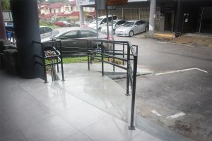 a parking lot with a bike rack in a parking lot at Vertilex Hotel in Johor Bahru