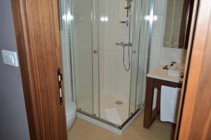 a bathroom with a shower and a toilet and a sink at Apartments B&P in Jahorina +31 photos