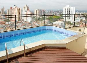 a swimming pool on the roof of a building at Travel Inn Saint Charles in Jundiaí