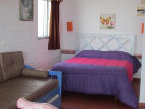 a bedroom with a bed and a couch in it at Terrazas De Punta Colorada in Piriápolis +178 photos