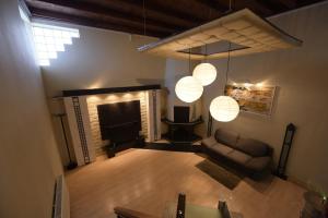 a living room with a couch and a fireplace at H & V Residence - Split Level Apartment in Arad