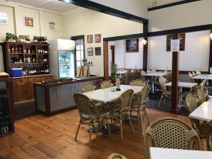 a restaurant with tables and chairs and a bar at Exchange Hotel Toogoolawah in Toogoolawah