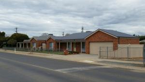 a brick house on the side of a street at Numurkah Self Contained Apartments - The Saxton in Numurkah