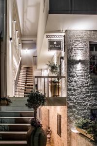 a lobby with stairs and a stone wall at Its Kale Boutique Hotel in Ioannina