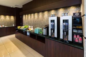 a hotel lobby with a counter with food and drinks at N Gate Hotel Osaka in Tajiri