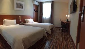 מיטה או מיטות בחדר ב-Goldmet Inn Changzhi Bayi Square