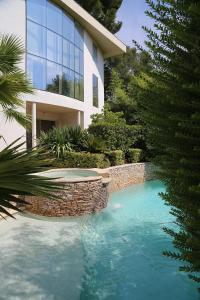 a swimming pool in front of a house at La Villa Saint Jean BAS DE VILLA in La Ciotat