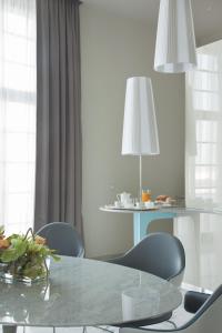 a dining room with a glass table and chairs at JR Hotels Bari Grande Albergo delle Nazioni in Bari