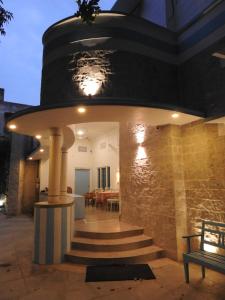 a building with a spiral staircase and a stone wall at Jaipur Jantar Hostel in Jaipur