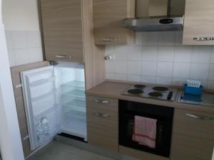 a kitchen with a stove and an open refrigerator at Roma alla Villa di Pompeo in Ladispoli