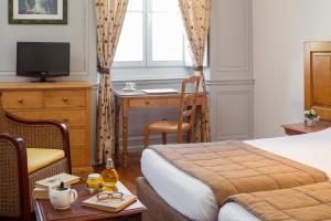 Postel nebo postele na pokoji v ubytování Appart Hotel Charles Sander