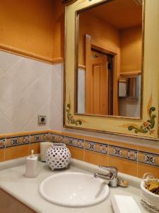 a bathroom with a sink and a mirror at Posada La Mies in Noja