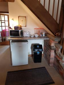 a kitchen with a counter with a microwave and a stove at Victoria Farm in Lutterworth