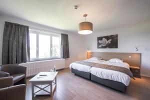 Postel nebo postele na pokoji v ubytování Hotel des Ardennes