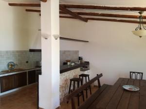 a kitchen and dining room with a table and chairs at Villa Mediterranea in Scopello
