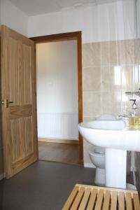 a bathroom with a white toilet and a sink at Inver bay apartment in Tain