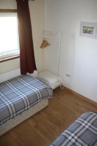 a room with two beds and a window at Inver bay apartment in Tain