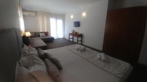 Postel nebo postele na pokoji v ubytování Family Hotel Muses