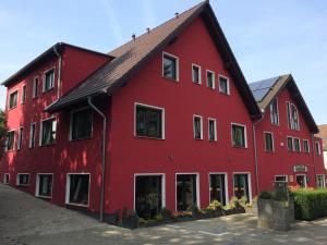a red building with a black roof at Bergcafè - Hotel Kammann in Essen