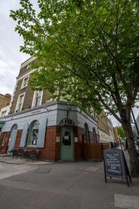 a brick building with a green door on a street at Central Station in London