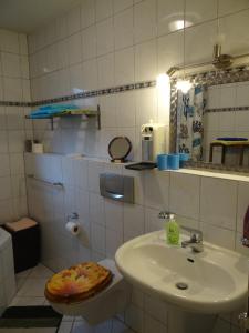 a white bathroom with a sink and a toilet at Apartment Gerda in Dieburg