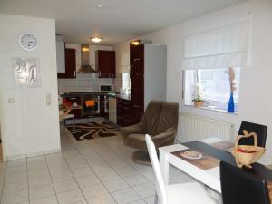 a kitchen and a living room with a table and chairs at Apartment Gerda in Dieburg
