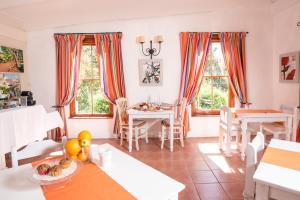a living room with a table and chairs and windows at Darling Lodge Guest House in Darling