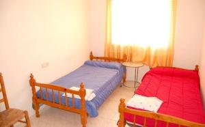 A bed or beds in a room at Casa Jasmin 1