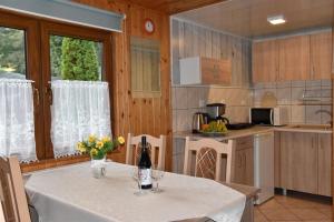 a kitchen with a table with wine glasses on it at Camping Baltic in Kołobrzeg