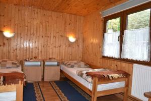 a bedroom with two beds and two windows at Camping Baltic in Kołobrzeg
