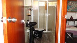a bathroom with a toilet and a sink in a room at Posada Nativa Miss Nova in San Andrés +62 photos