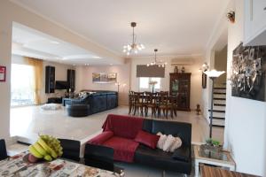 a living room with a couch and a table at Villa Amfimala in Georgioupolis