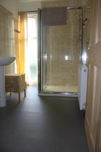 a bathroom with a shower and a sink at Inver bay apartment in Tain