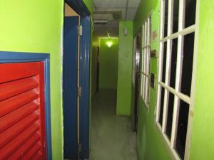 a hallway of a room with green and blue walls at Oasis Guest House in Kuala Lumpur +40 photos
